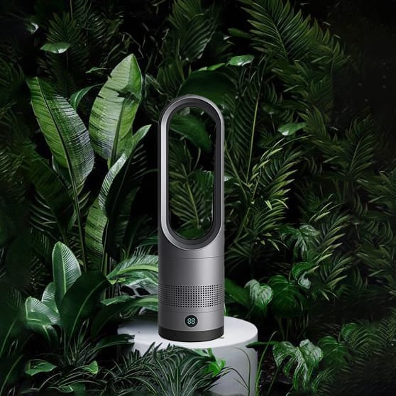 Grauer Turmventilator in Form eines Ovals mit Pflanzenhintergrund