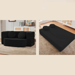 Schwarzes AirBloom Sofa mit zwei runden Kissen aufgestellt und in ein Bett ausgeklappt